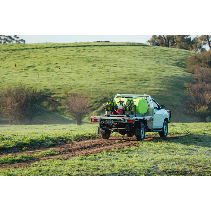 SuperReel 1000L Twin Reel Slip On Field Sprayer spraying on hillside