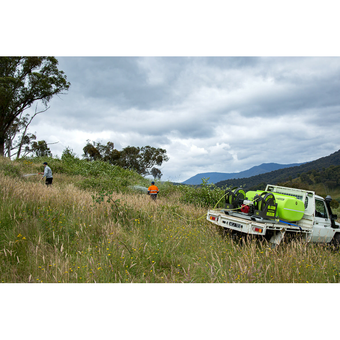 SuperReel 400L Short Twin Reel Slip On Field Sprayer spraying on hillside
