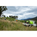 SuperReel 400L Short Twin Reel Slip On Field Sprayer spraying on hillside