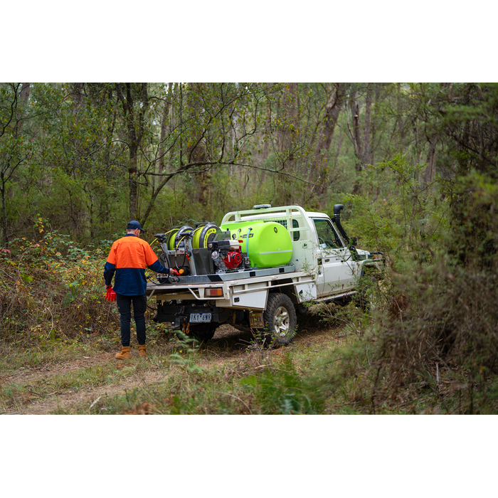 Operator spraying weeds from a ute with the SuperReel M-Series 1200L spray unit