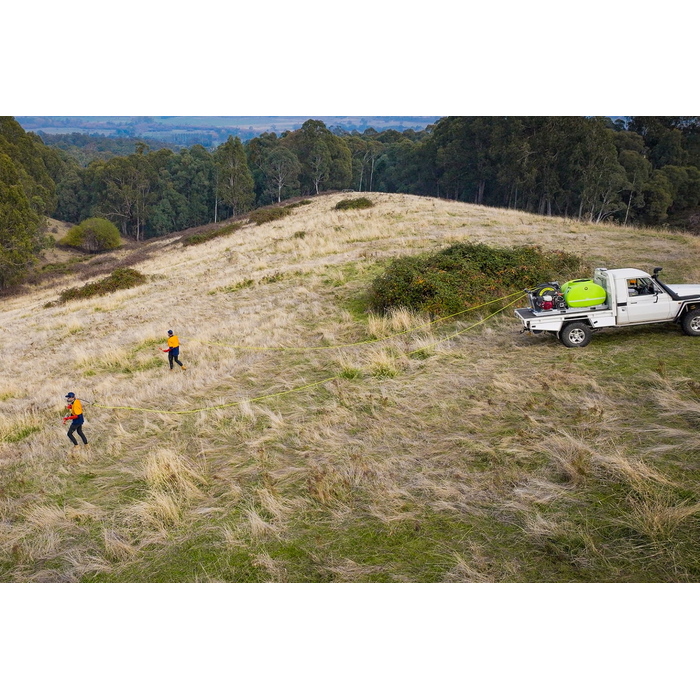 Aerial view of two operators spraying a hillside from a SuperReel M-Series unit on a ute