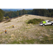 Aerial view of two operators spraying a hillside from a SuperReel M-Series unit on a ute