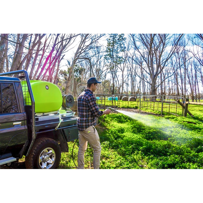 Hose spraying from a flatbed ute with a TopCrop slip on sprayer