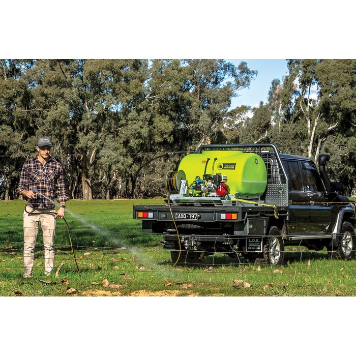Hose spraying from a flatbed ute with a TopCrop slip on sprayer