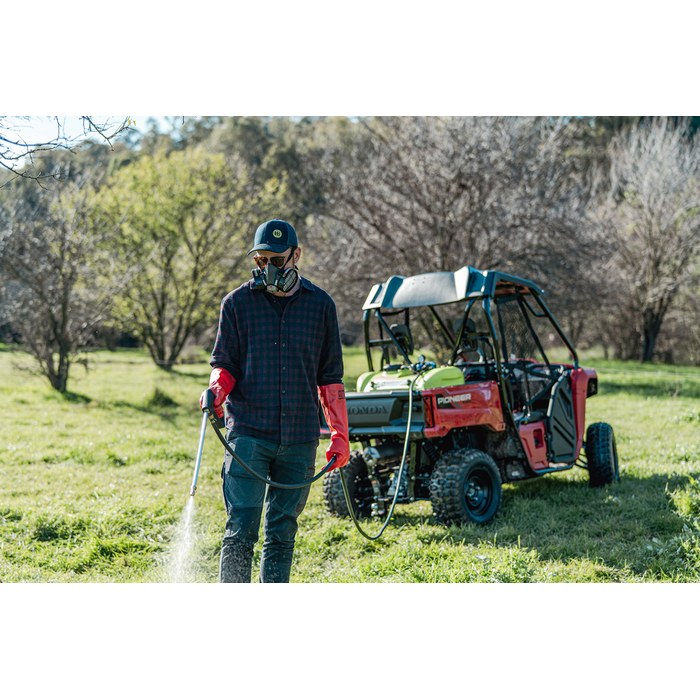 Operator spraying weeds with a WeedControl 225L 12v spot sprayer carried on a UTV