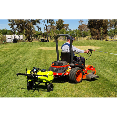 Zero turn mower towing a WeedControl spot sprayer trailer with a boom and spray gun