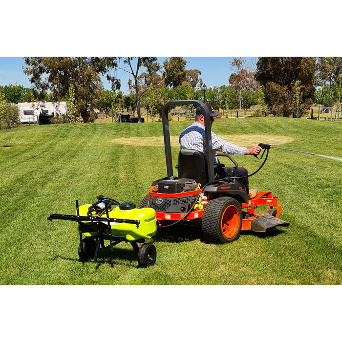 Zero turn mower towing a WeedControl spot sprayer trailer with a boom and spray gun